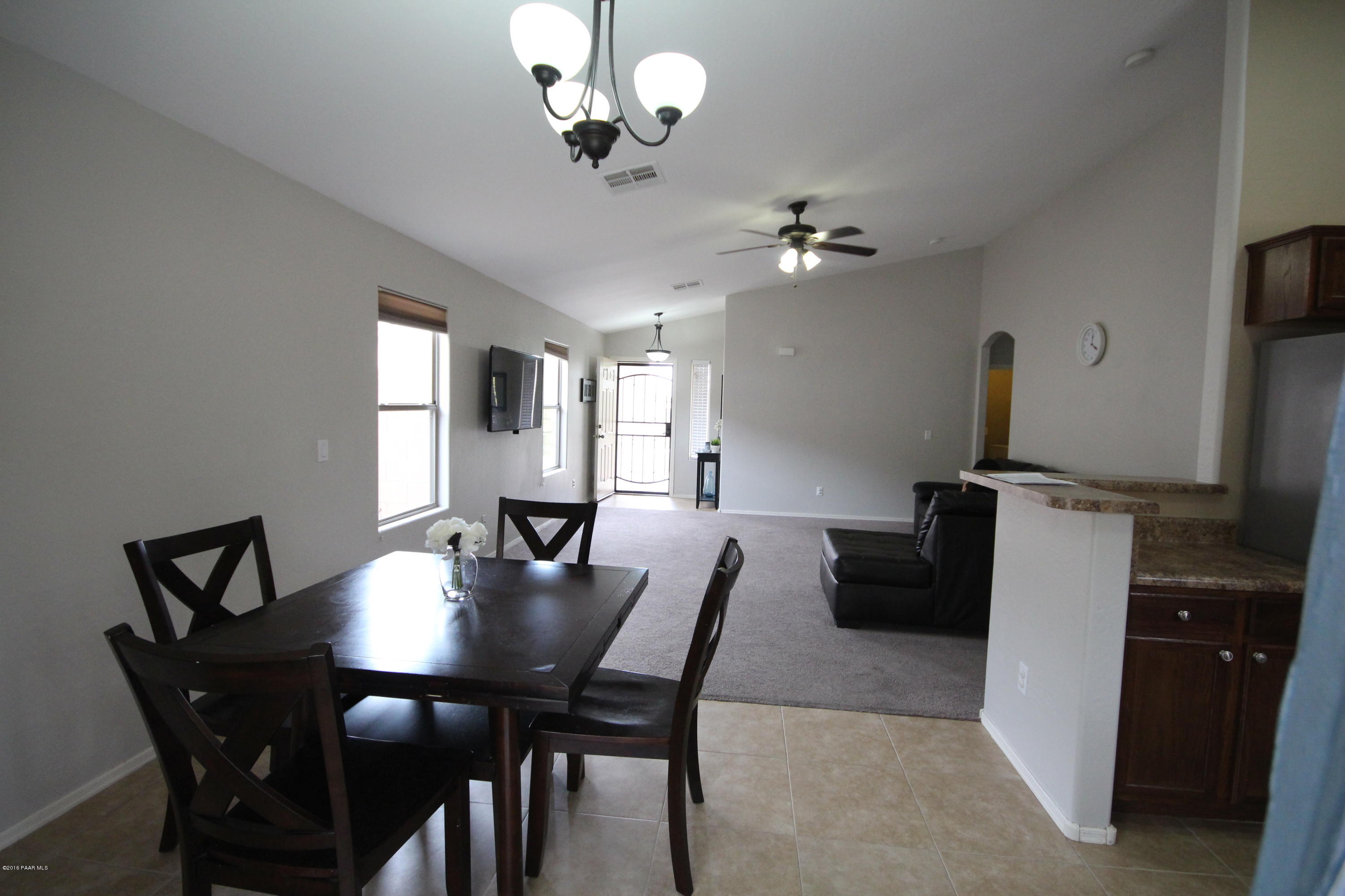 7449 East Plateau Ridge Road Prescott Valley, AZ 86315 - Photo 5 of 17 a view of a dining room with furniture and a chandelier