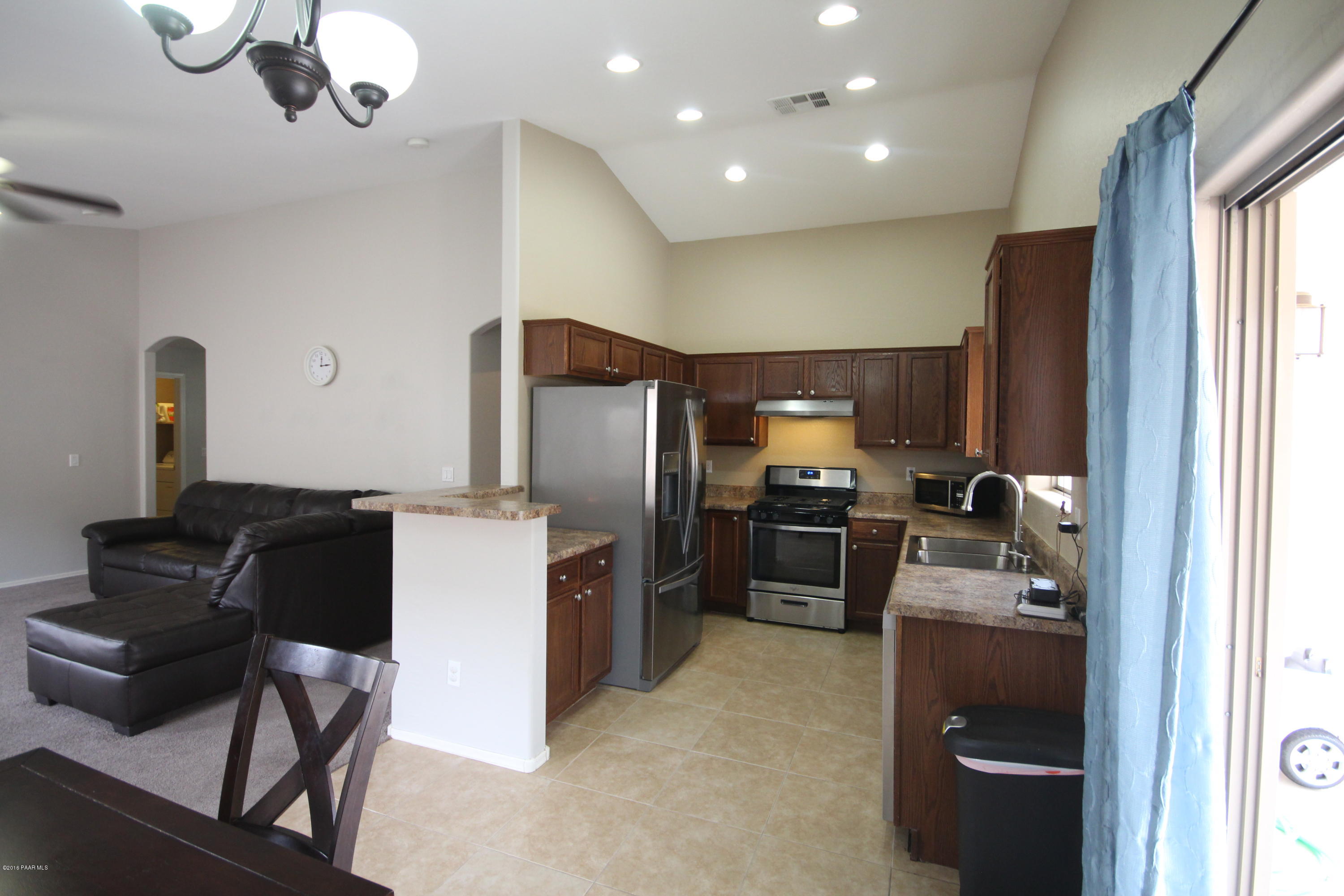 7449 East Plateau Ridge Road Prescott Valley, AZ 86315 - Photo 7 of 17 a kitchen with a refrigerator and a stove top oven