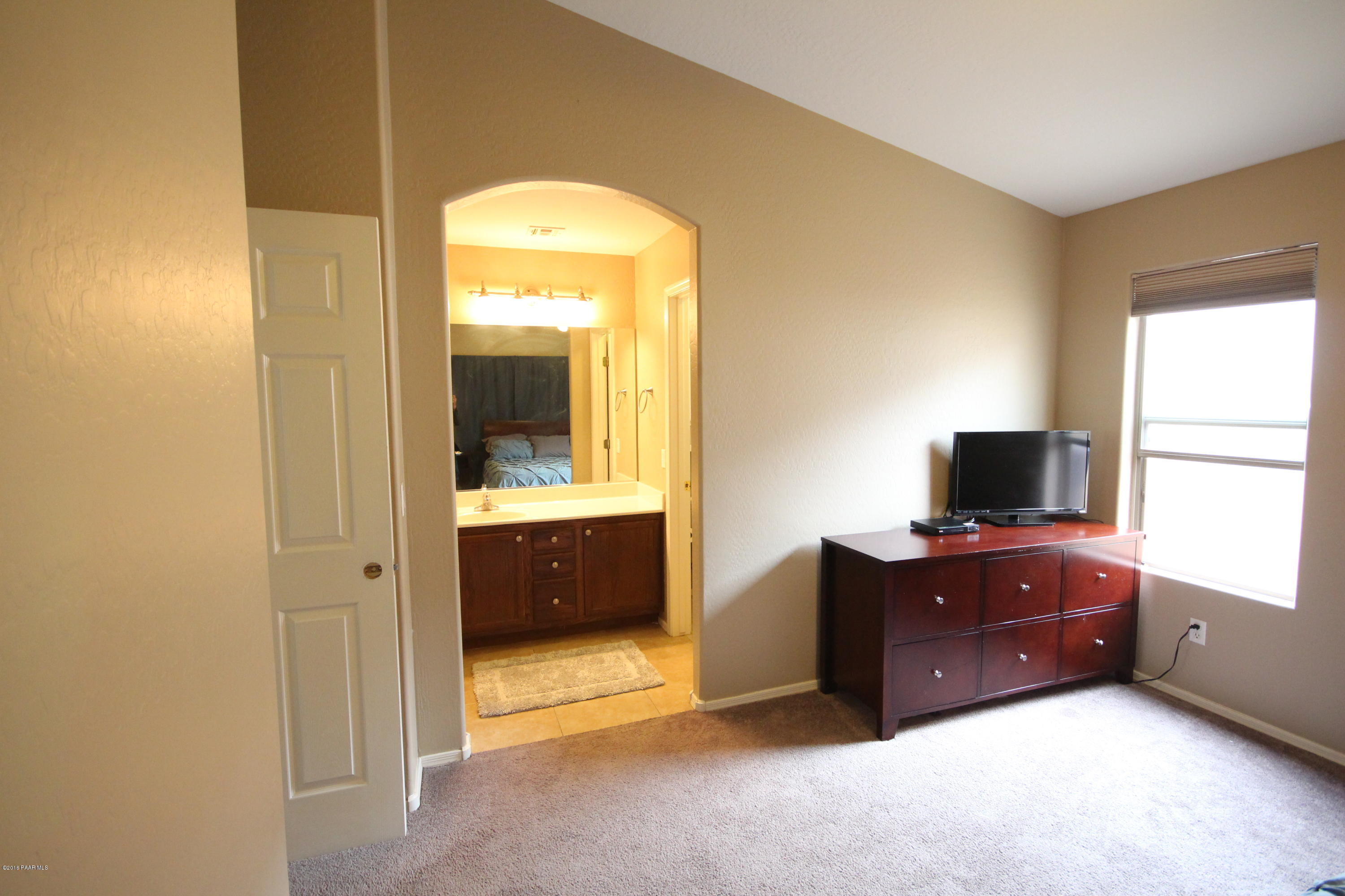 7449 East Plateau Ridge Road Prescott Valley, AZ 86315 - Photo 10 of 17 a living room with furniture and a flat screen tv