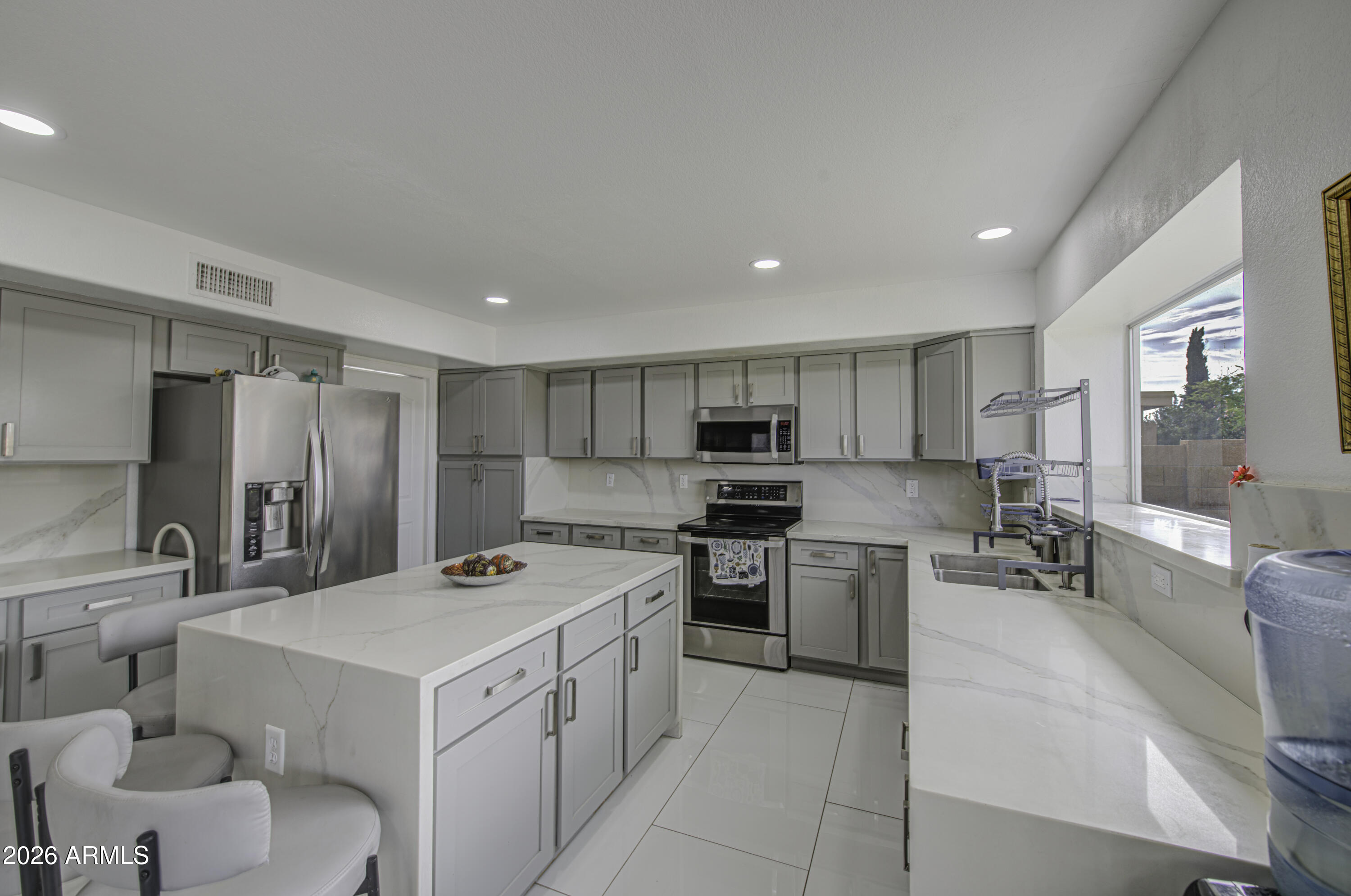 12403 West Monte Vista Road Avondale, AZ 85392 - Photo 22 of 63 a kitchen that has a sink and a stove in it