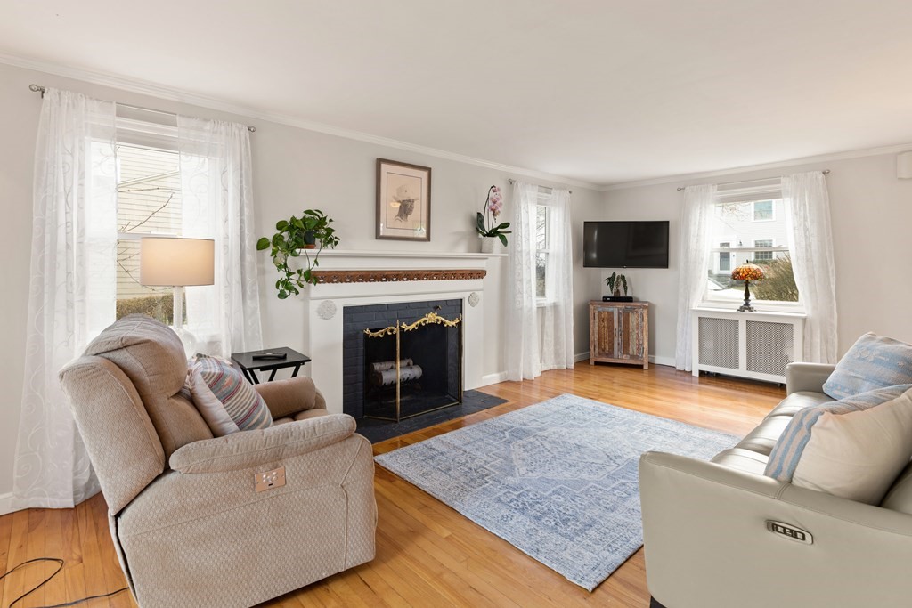 38 Magnolia Road Milton, MA 02186 - Photo 5 of 34 a living room with furniture and a fireplace