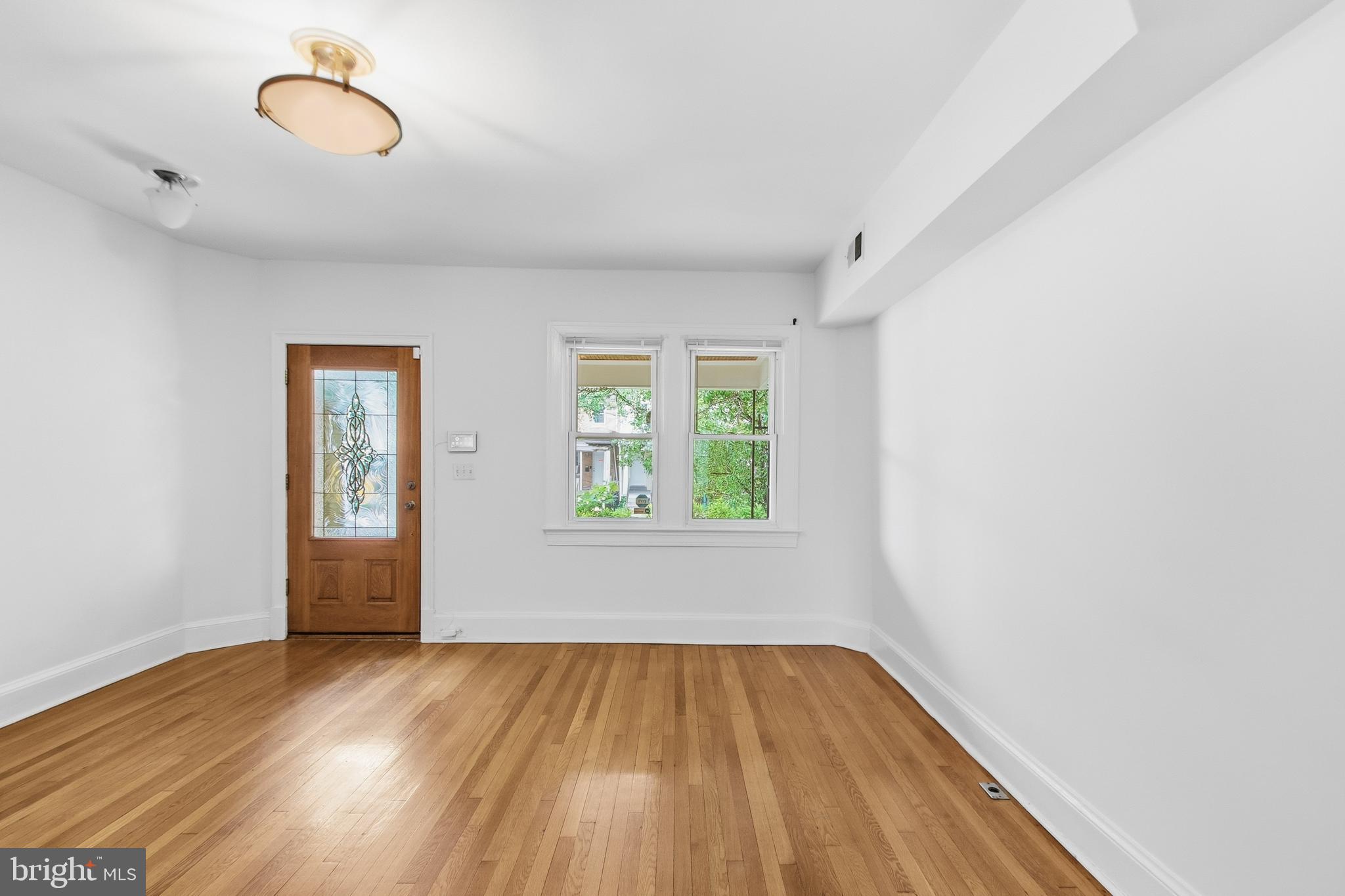 440 Delafield Place Northwest Washington, DC 20011 - Photo 8 of 33 an empty room with wooden floor and windows