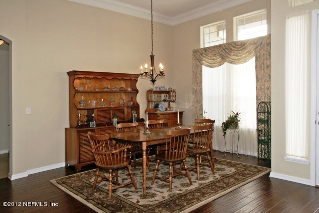 1300 Powis Road St. Augustine, FL 32095 - Photo 8 of 41 a view of a dining room with furniture and wooden floor