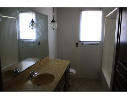3305 Meadow Ridge Drive Corpus Christi, TX 78418 - Photo 5 of 9 a bathroom with a sink and a mirror
