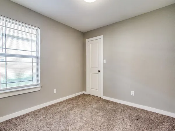 a view of an empty room and a window