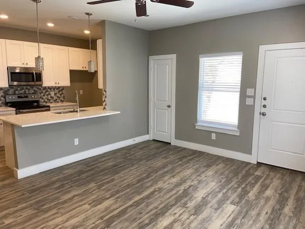 a view of kitchen with window and stainless steel appliances