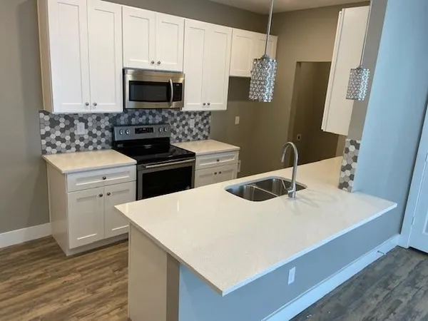 a kitchen with a sink stove and microwave