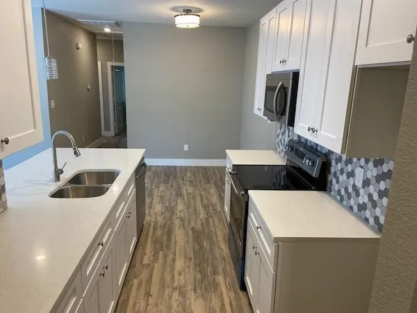 a kitchen with a sink and a refrigerator