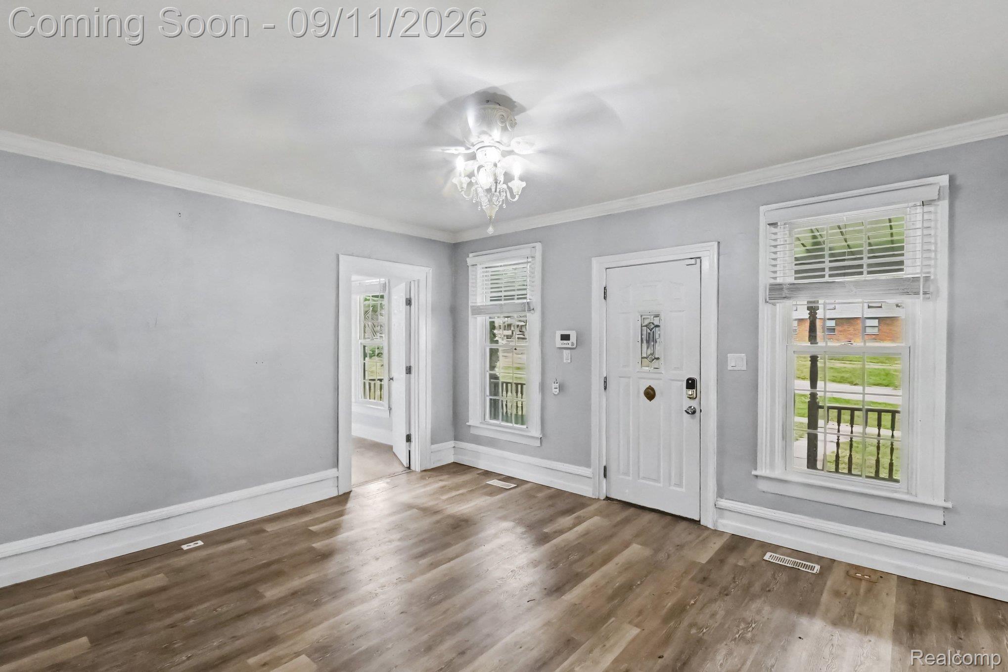 409 Fleming Street Howell, MI 48843 - Photo 3 of 25 Wood-finish flooring throughout, white trim, and light gray walls