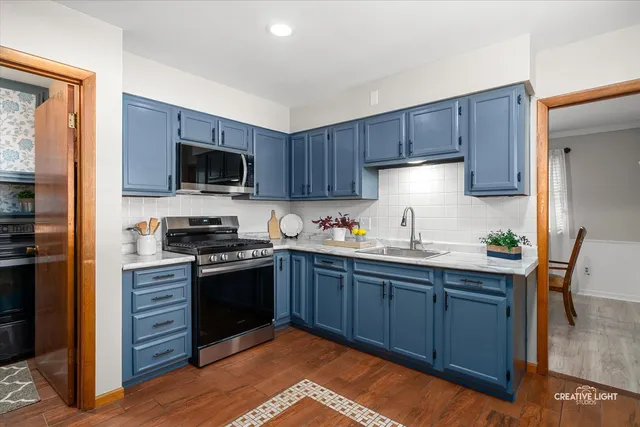 a kitchen with wooden cabinets and stainless steel appliances