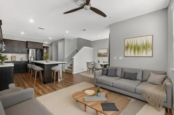 a living room with furniture kitchen view and a dining table