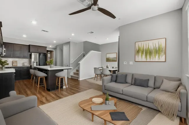 a living room with furniture kitchen view and a dining table