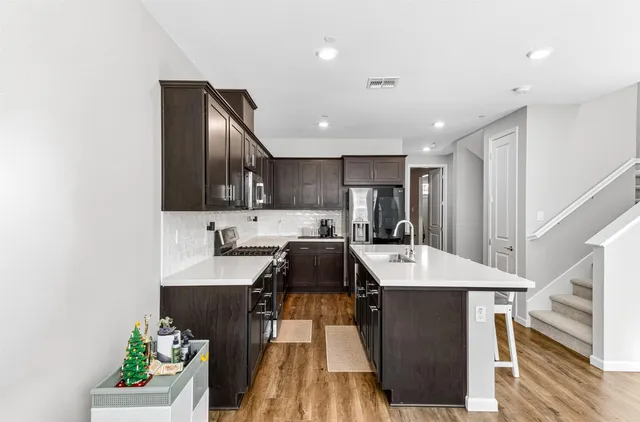 a kitchen with a sink appliances and cabinets
