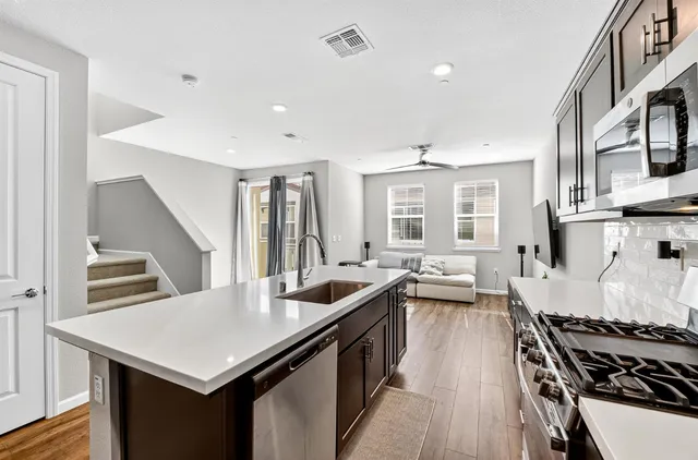 a kitchen with stainless steel appliances granite countertop a stove and a sink