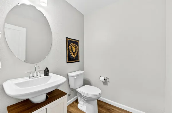 a bathroom with a toilet a sink and mirror