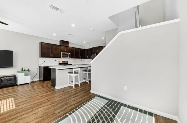 a kitchen with stainless steel appliances a refrigerator and a stove top oven