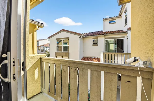 a view of a balcony with wooden floor and fence