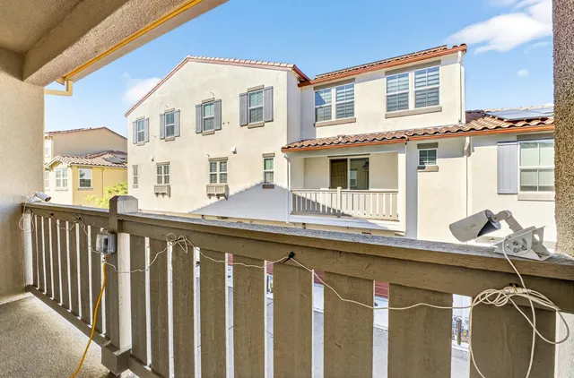 a balcony view with an outdoor seating