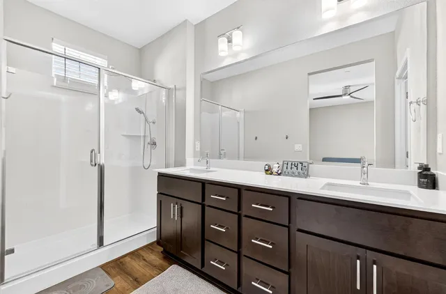 a bathroom with a double vanity sink mirror and double