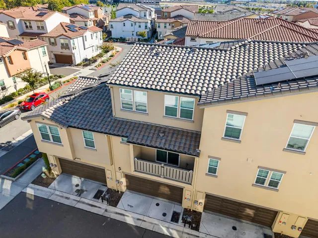 a roof deck with table and chairs