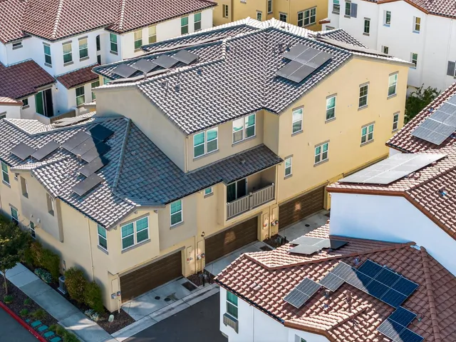 an aerial view of a house with a yard