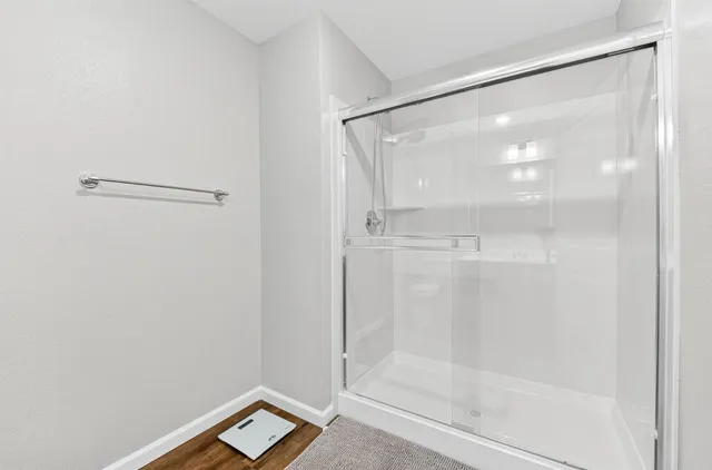 a bathroom with a glass shower door