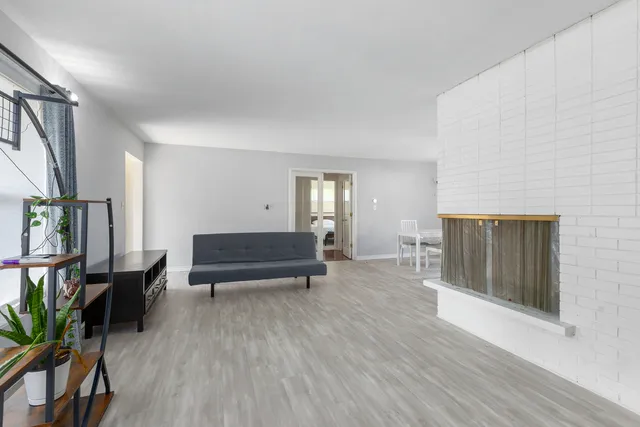 a room with wooden floor and furniture