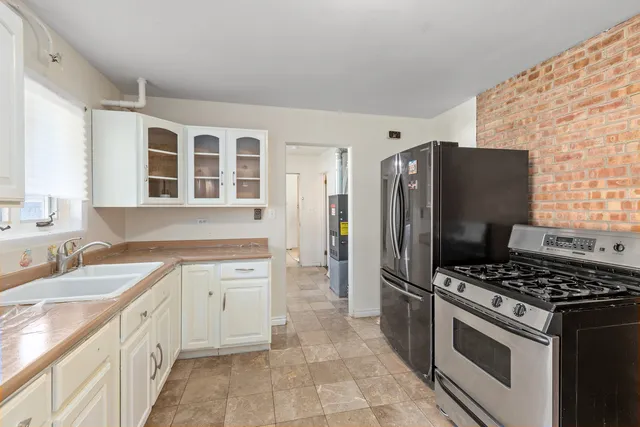 a kitchen with stainless steel appliances a refrigerator sink and stove