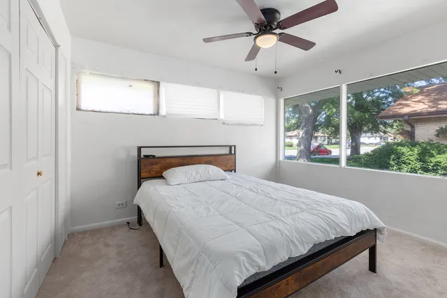 a bedroom with a large bed and a large window