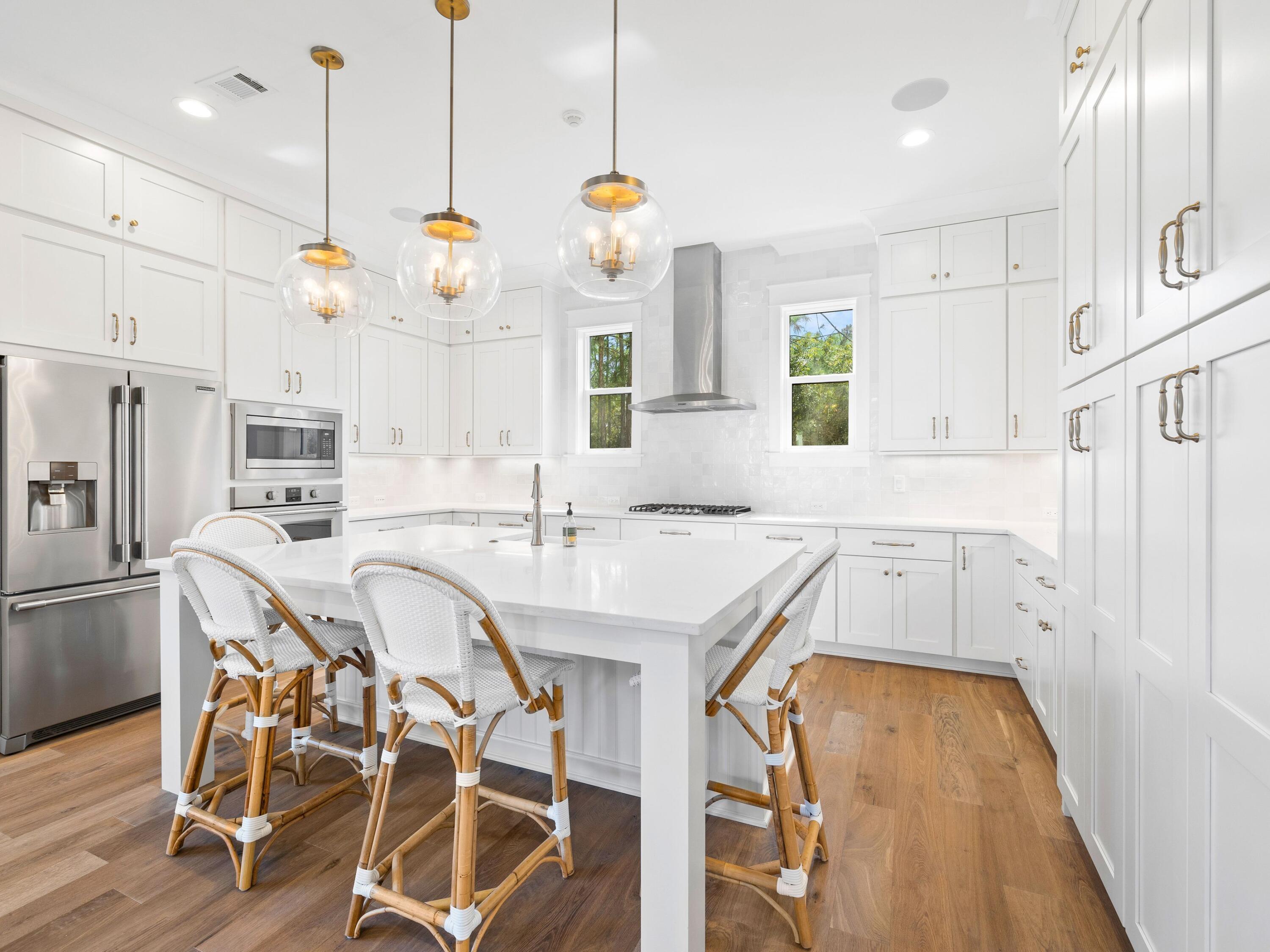 425 Ridgewalk Circle Santa Rosa Beach, FL 32459 - Photo 1 of 22 a kitchen with wooden cabinets and white appliances