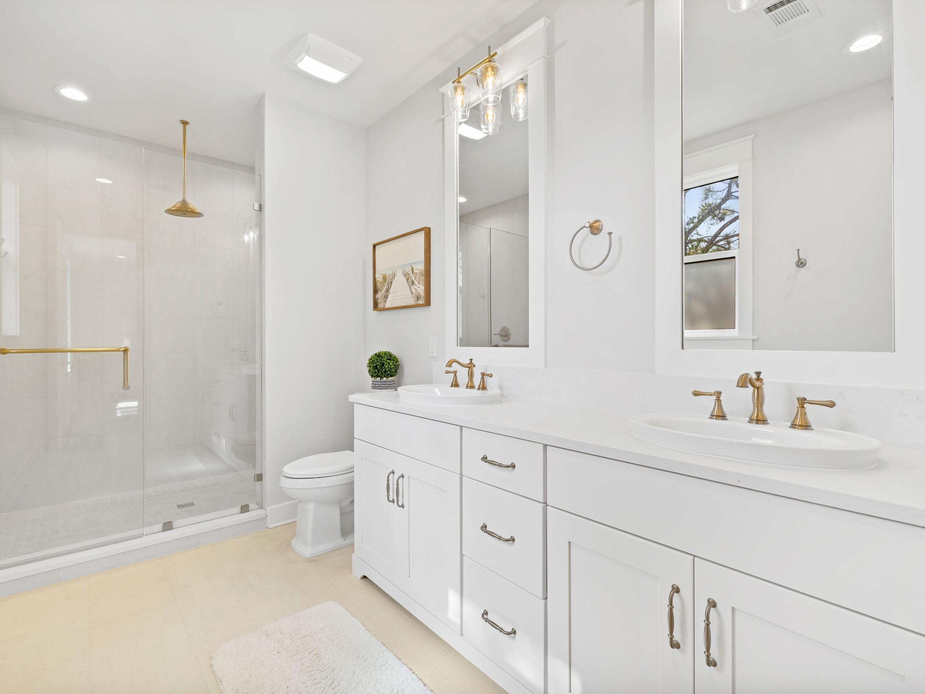 425 Ridgewalk Circle Santa Rosa Beach, FL 32459 - Photo 13 of 22 a bathroom with a double vanity sink toilet mirror and shower