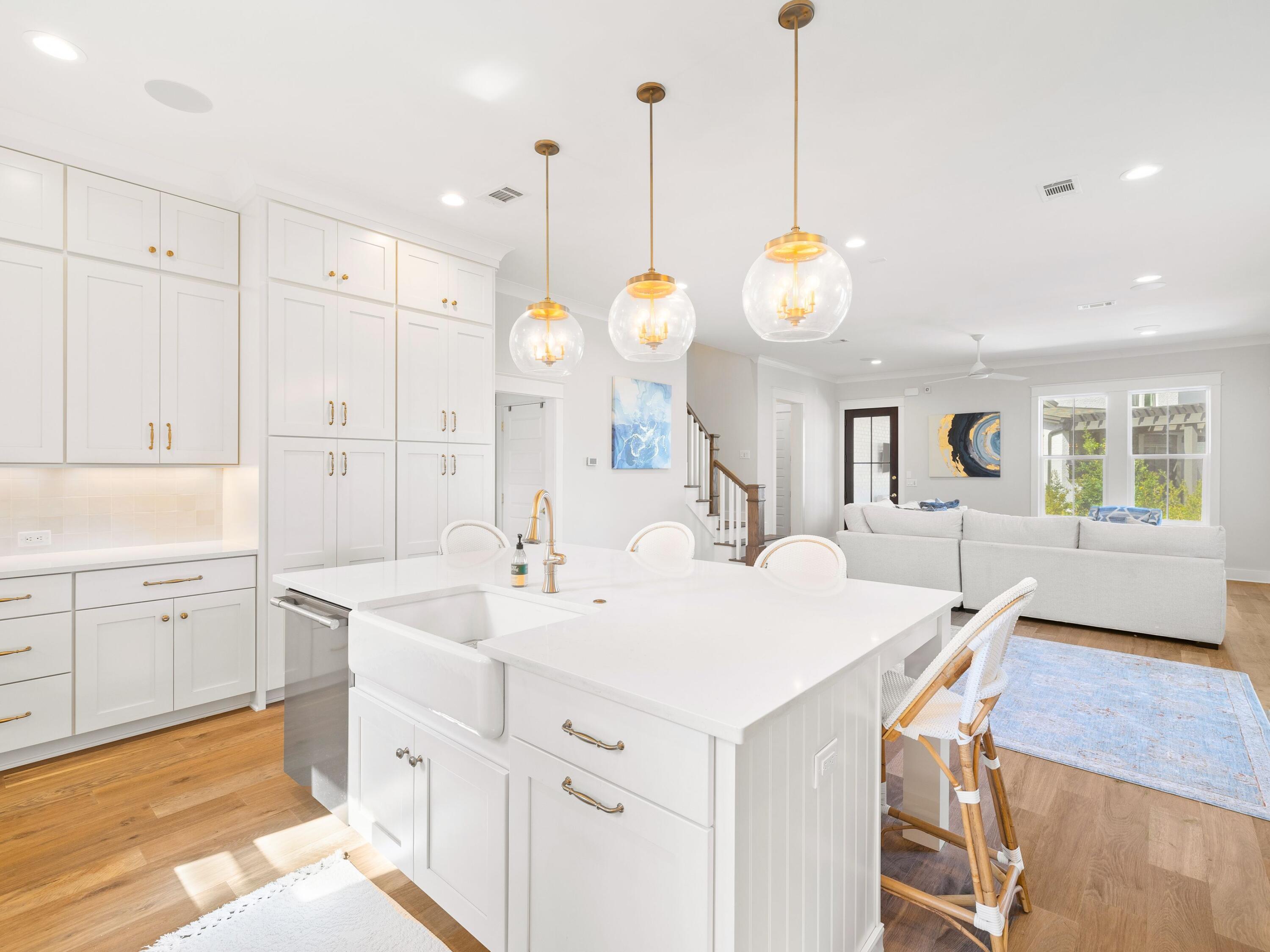425 Ridgewalk Circle Santa Rosa Beach, FL 32459 - Photo 2 of 22 a kitchen with a sink and dishwasher with white cabinets