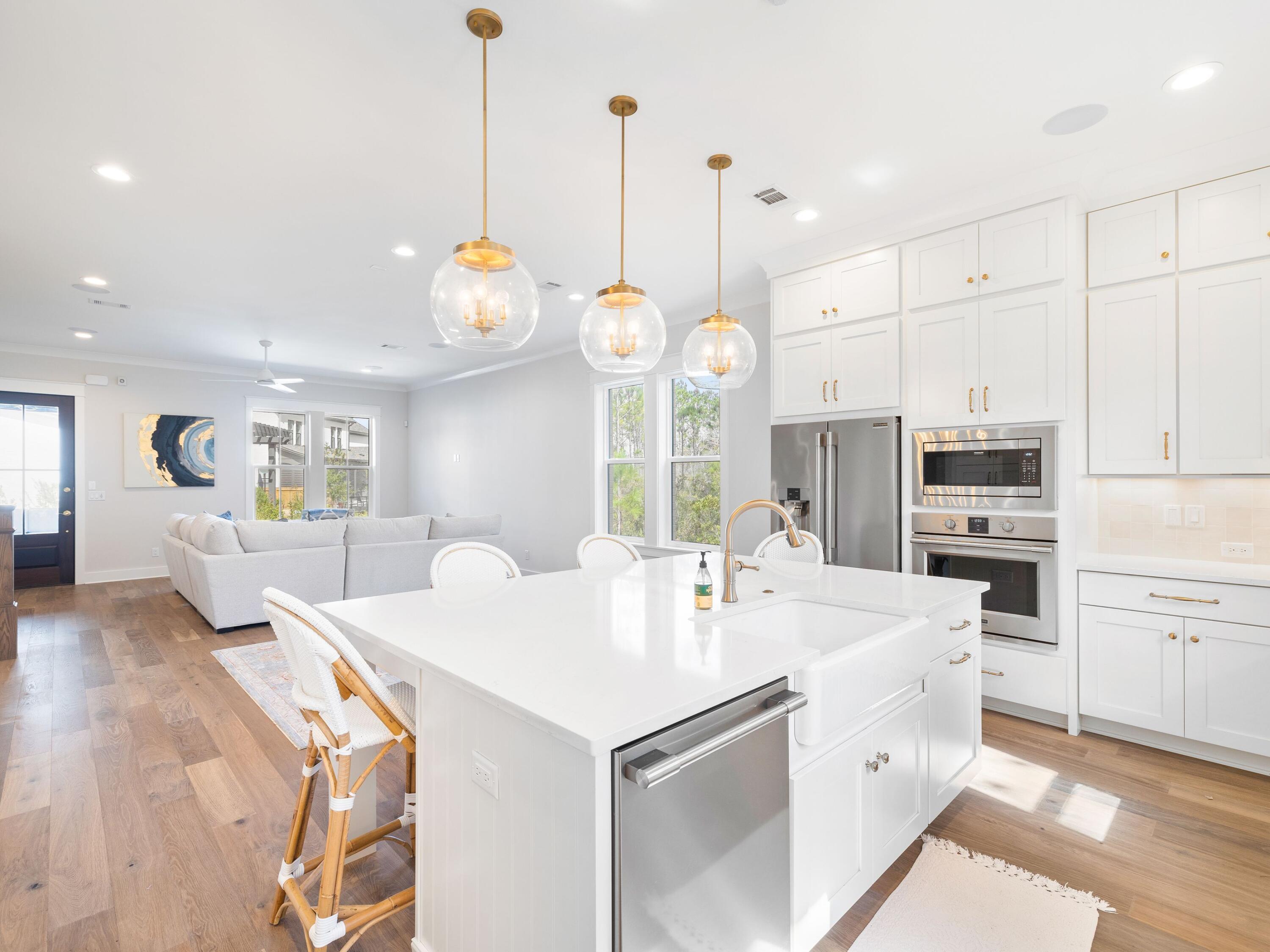 425 Ridgewalk Circle Santa Rosa Beach, FL 32459 - Photo 3 of 22 a kitchen with kitchen island white cabinets and stainless steel appliances