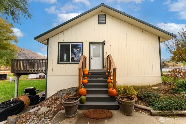 a front view of house with yard outdoor seating and barbeque oven