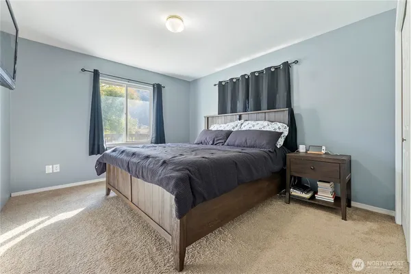 a bed sitting in a bedroom next to a window