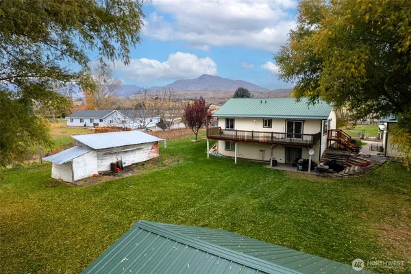 a view of a house with a backyard porch and sitting area