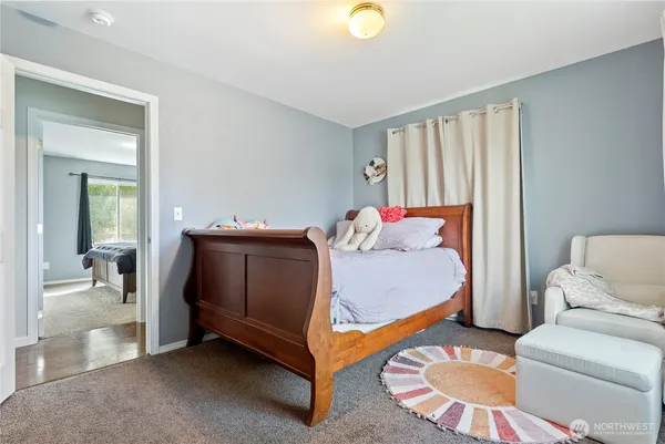 a bedroom with a bed and couch