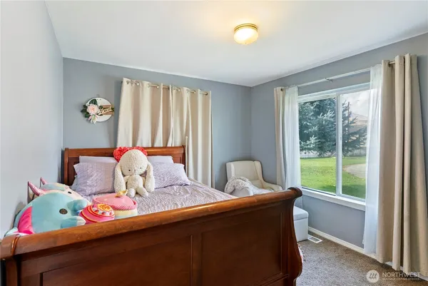 a bedroom with a bed and glass window