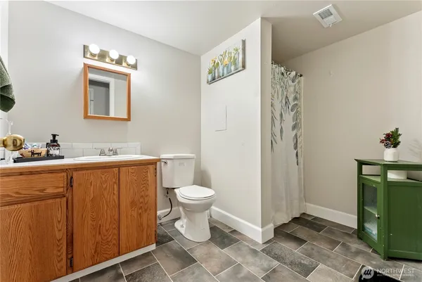 a spacious bathroom with a toilet sink and a mirror