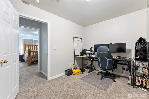 a view of a workspace with furniture and a window