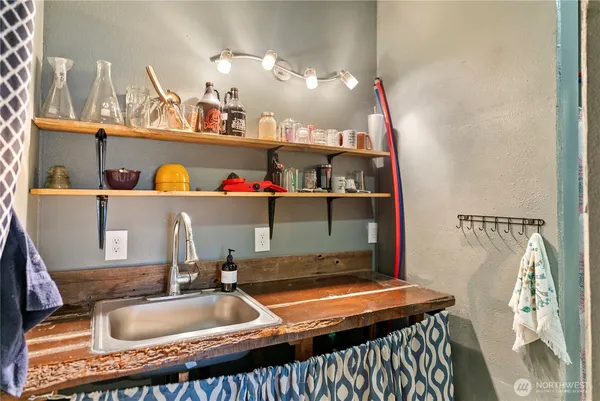 a room with water heater and shelf