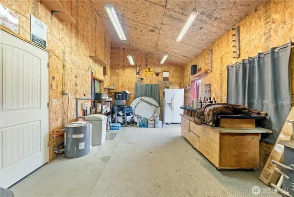 a view of a chairs and tables in the back yard of a house