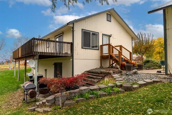 a view of a house with wooden fence