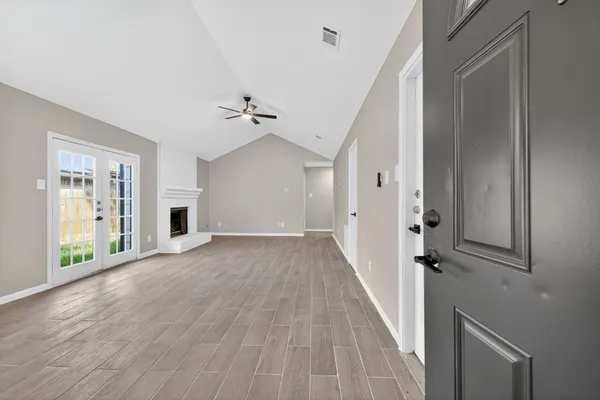 wooden floor in an empty room with a window
