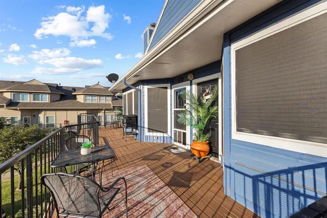 a dining room with wooden floor a chandelier a wooden table and chairs