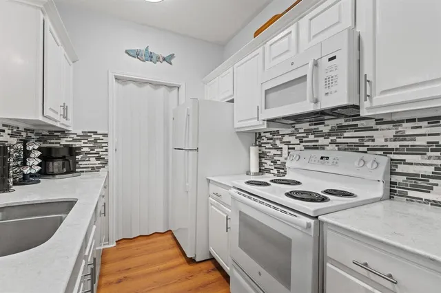 a kitchen that has a sink and a stove