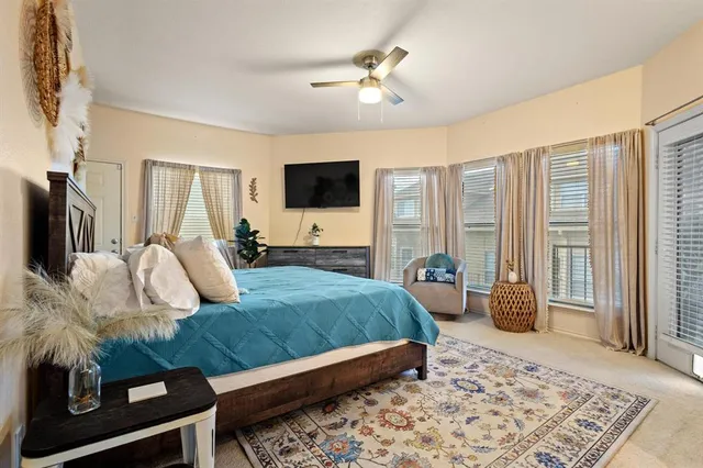 a bedroom with a bed a couch and a chandelier