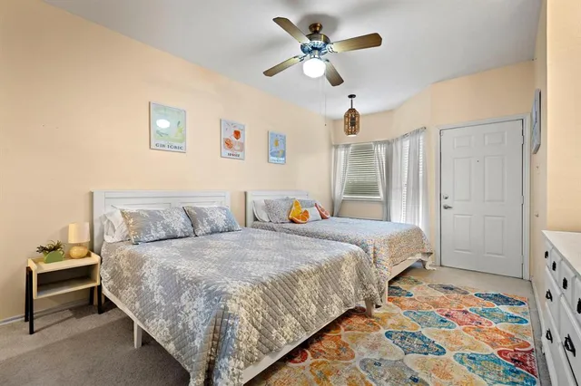 a bedroom with furniture and a flat screen tv