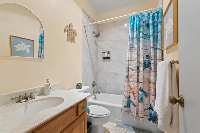 a bathroom with a sink toilet and a mirror