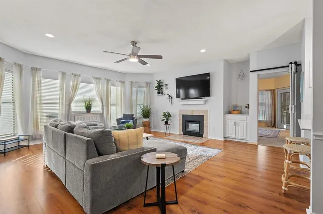 a living room with furniture a fireplace and a potted plant